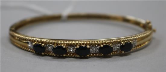 A boxed 9ct gold, sapphire and diamond hinged bangle.